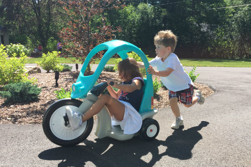 Children racing in their Super Coupe Pedal Trike