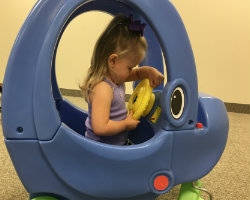 Little girl steering Elly Coupe