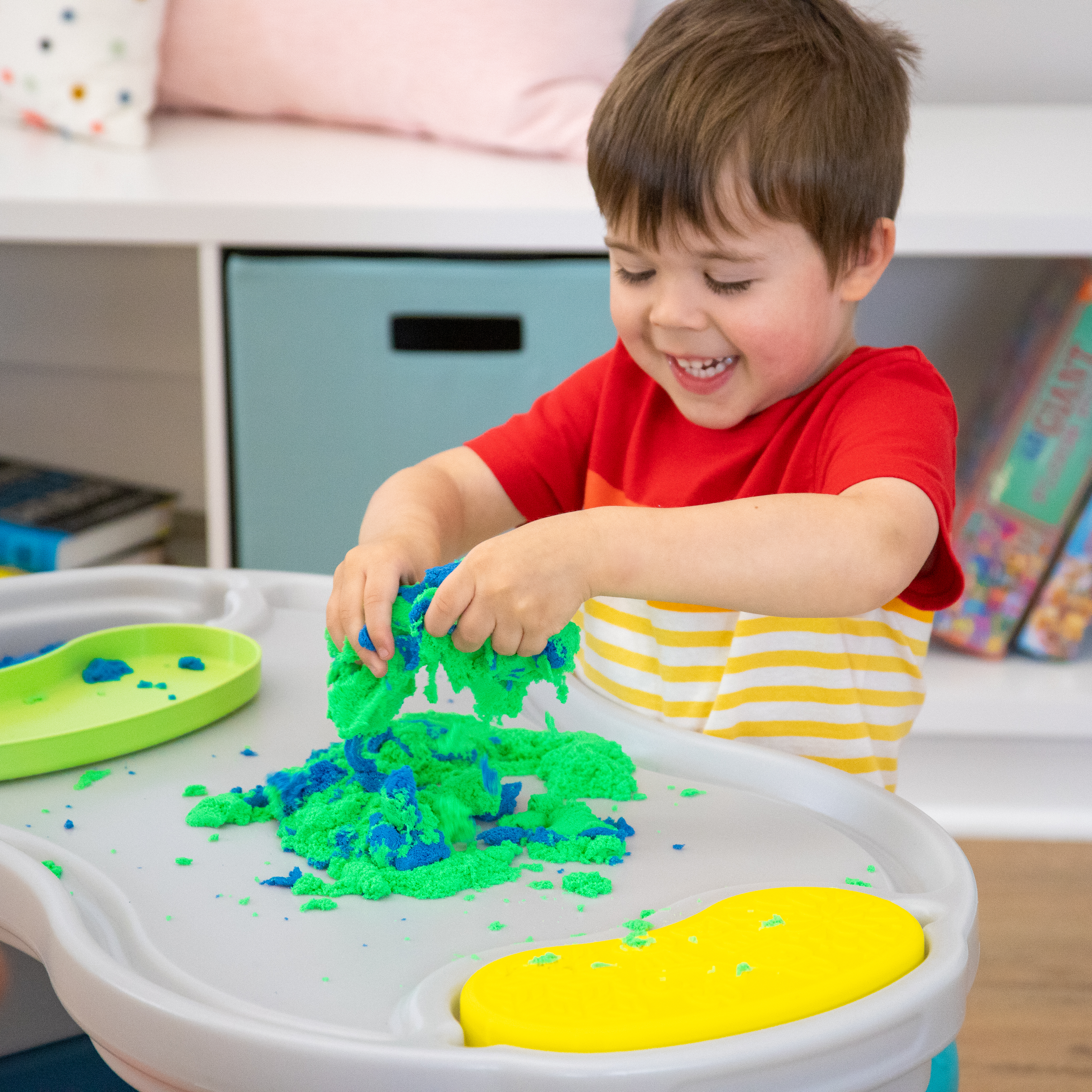 kinetic sand being played with on the simplay3 creative kids sensory play table