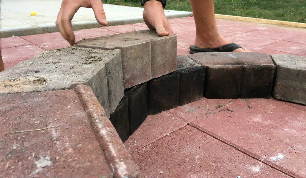 Lay second ring of DIY fire pit with small gap between each block