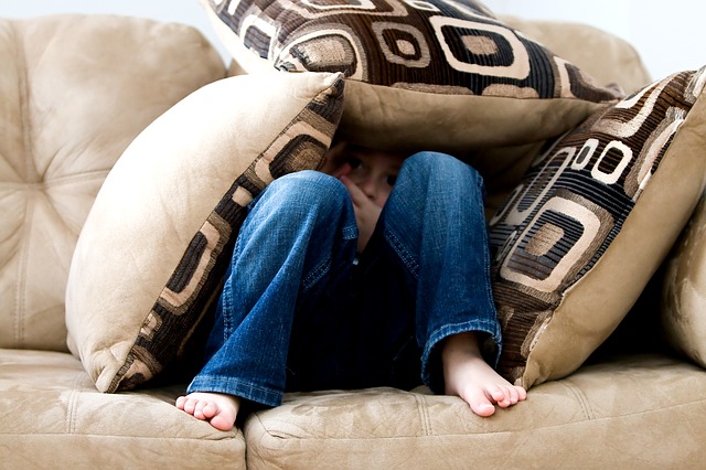 Little boy in pillow fort