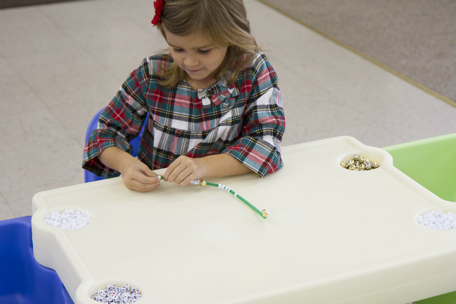 Work on fine motor skills and much more putting beads on the ornament